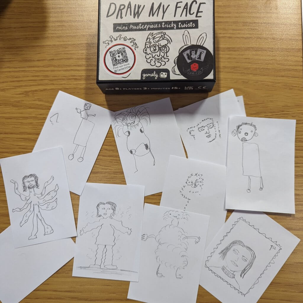 Draw my Face card game box with drawings we did while playing. 