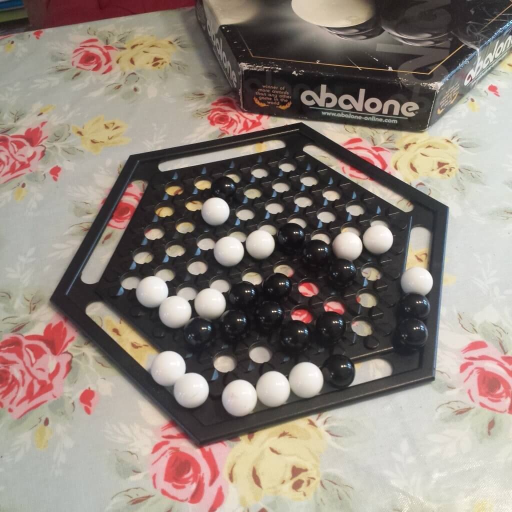 abalone a game that involves pushing large marbles off a board
