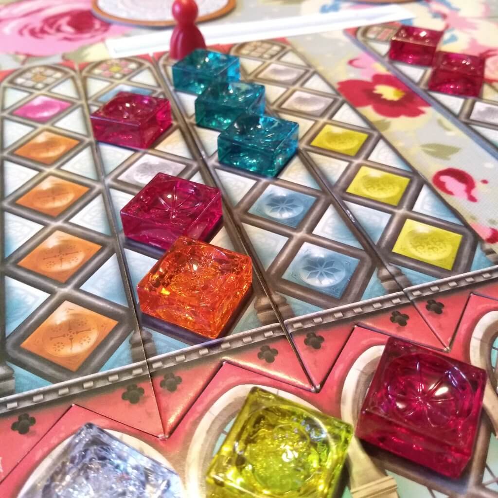 A game with shiny cubes and a pawn. The game is Azul Sintra