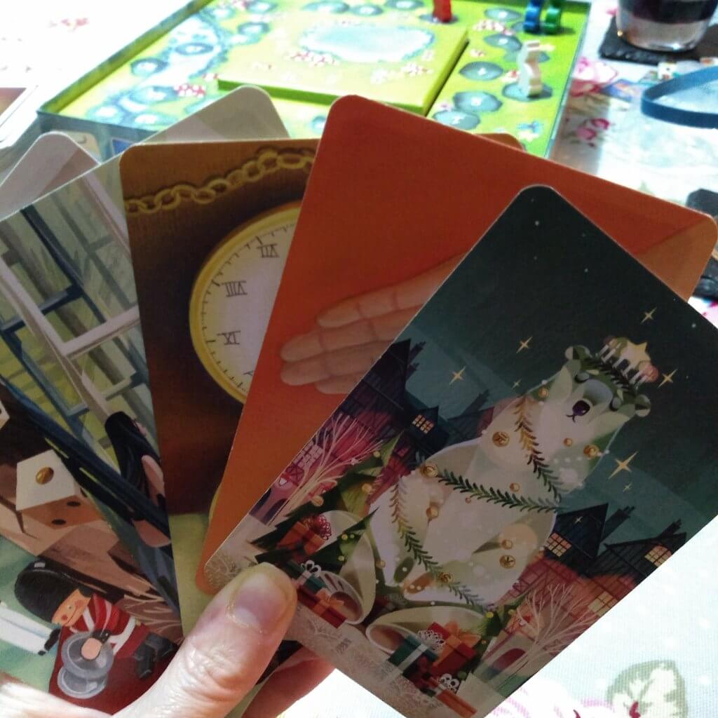 Some of the cards in Dixit. The board is in the distance behind the cards