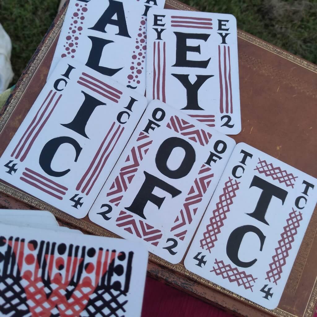 The Ell deck. Cards are lined up. Each card has a decorative border and features two large letters. 