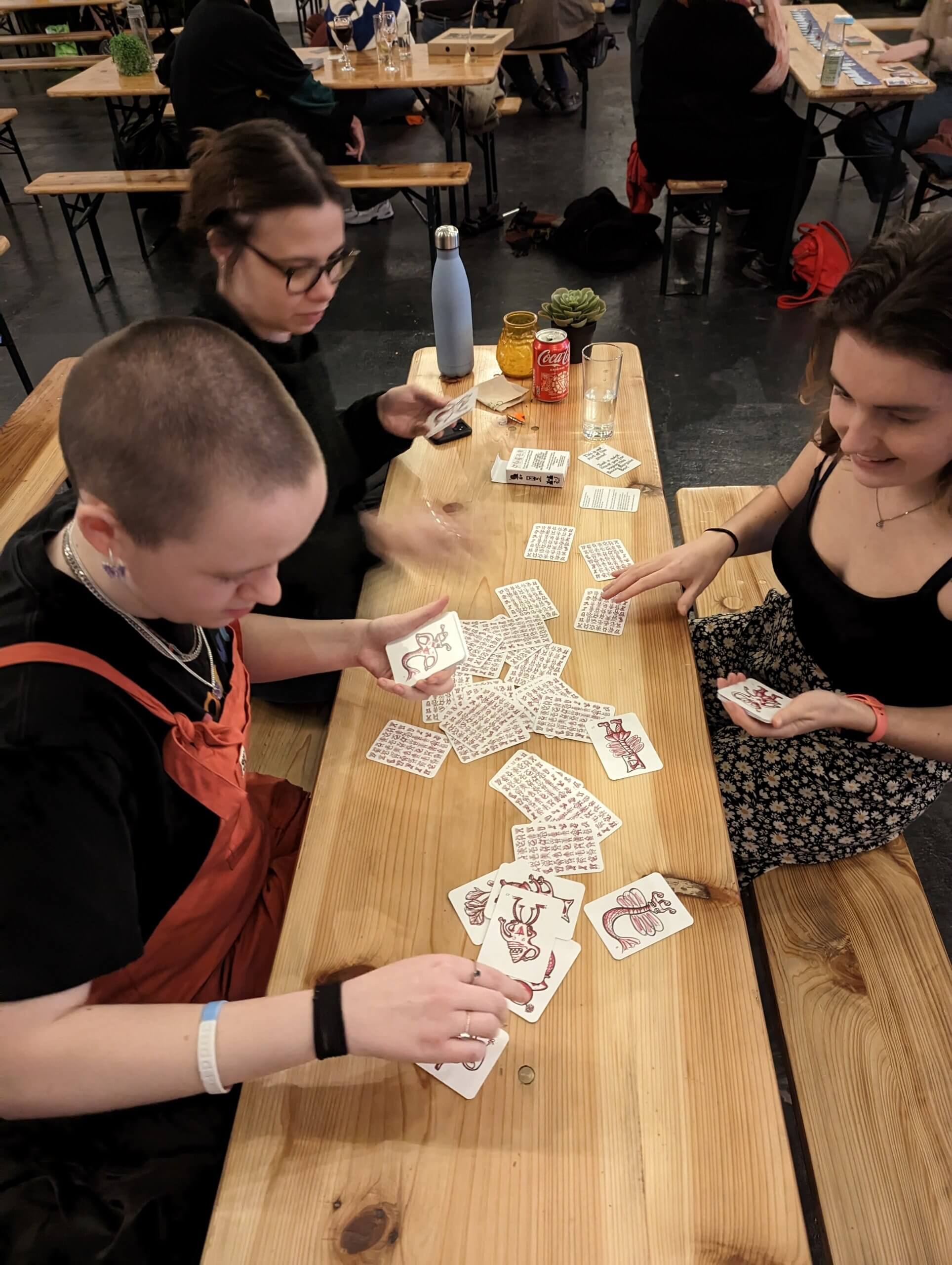 People playing the beetroots game. Cards are scattered on the table