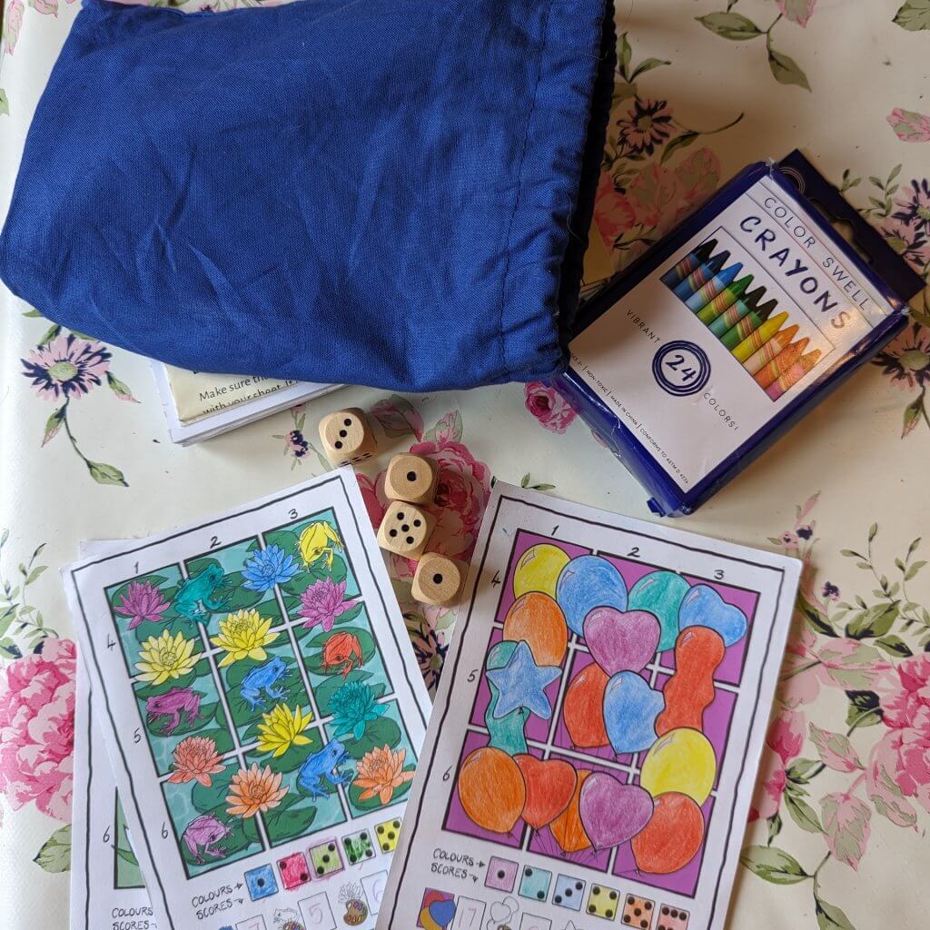 Image of completed roll and colour games, dice and crayons. 