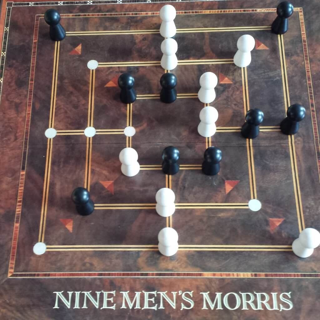 Nine men's morris. A traditional strategy game requiring you to get three of your pieces in a line. 